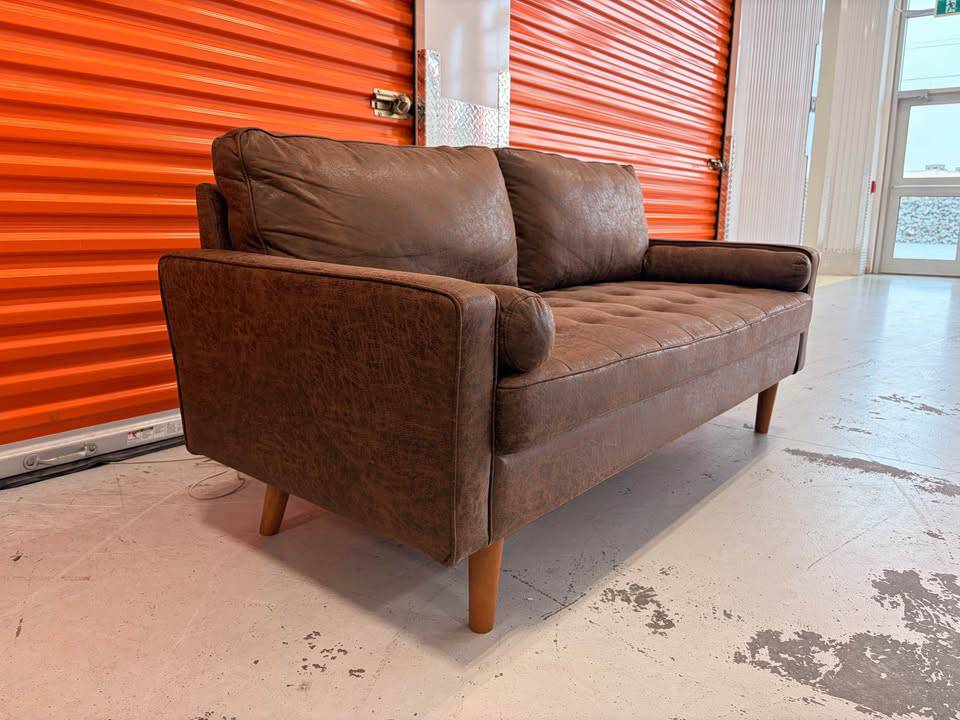 Like new suede modern couch with clean lines and plush cushions, designed for stylish living rooms.