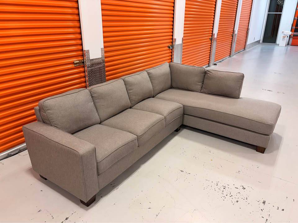 Big right-facing sectional with built-in charging ports by Cameron's Furniture, featuring plush cushions and modern design.