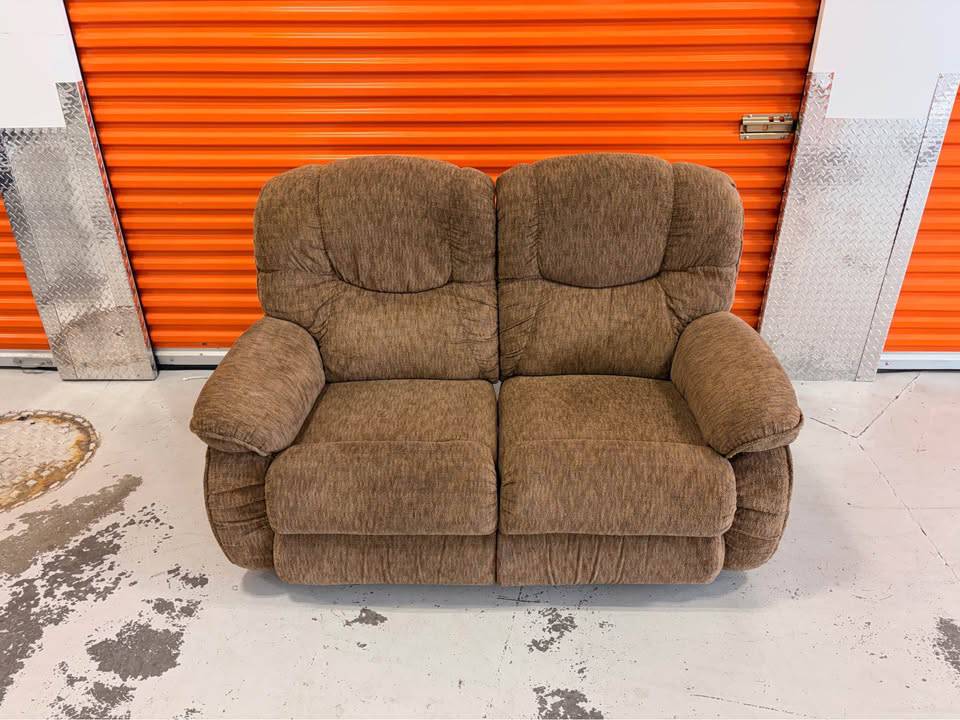 La-Z-Boy loveseat recliner sofa with plush fabric and cushioned armrests, designed for comfortable seating and relaxation.